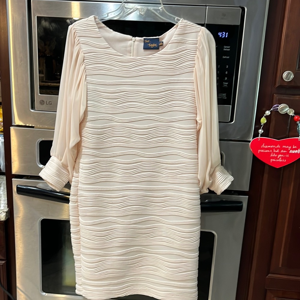 Woman’s crème dress with sheer sleeves